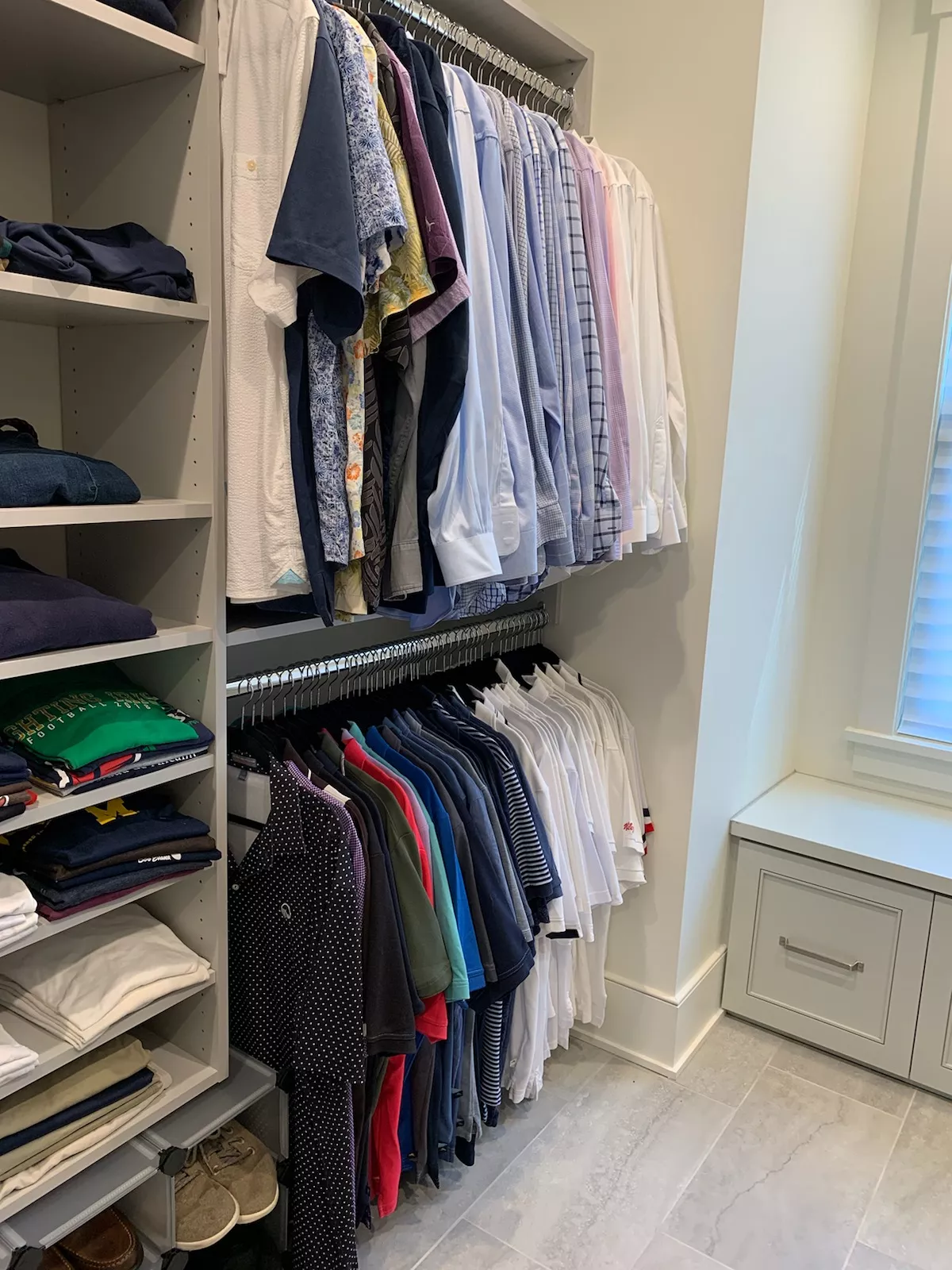Organized clothing closet with hanging shirts and folded clothes